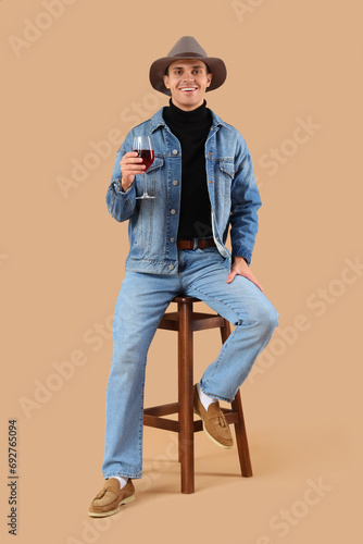 Young man with glass of win...