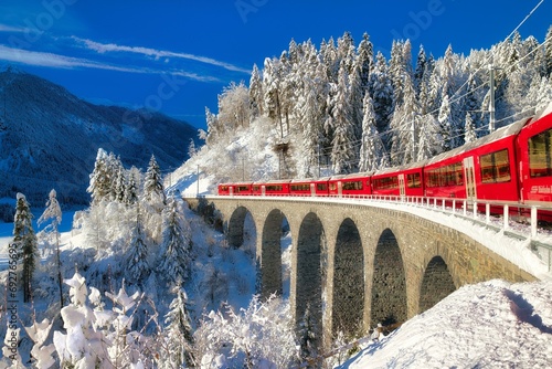 Rhaetian railway on viaduct in winter landscape, near Filisur, Canton Graubuenden, Switzerland, Europe photo