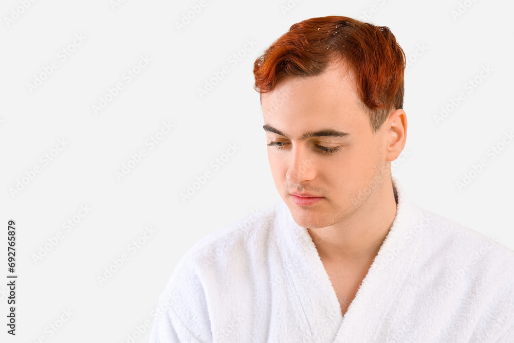 Young redhead man with problem of dandruff on light background Young redhead man with problem of dandruff on light background