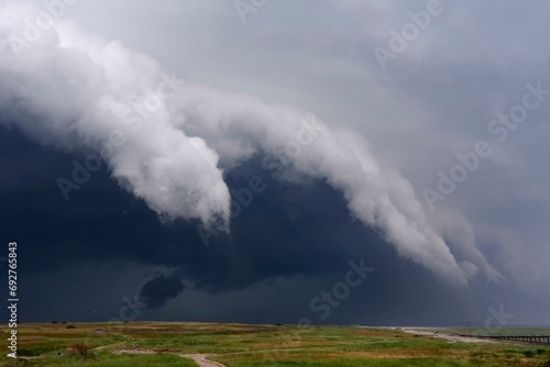 Stormy atmosphere on the island of Minsener Oog, dramatic cloud formations, Lower Saxony Wadden Sea National Park, Lower Saxony, Germany, Europe photo