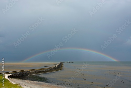 View from the radar tower of Minsener Oog Island onto the jetty with rainbow, Lower Saxony Wadden Sea National Park, Lower Saxony, GermanyLower Saxony Wadden Sea National Park, Lower Saxony, Germany photo