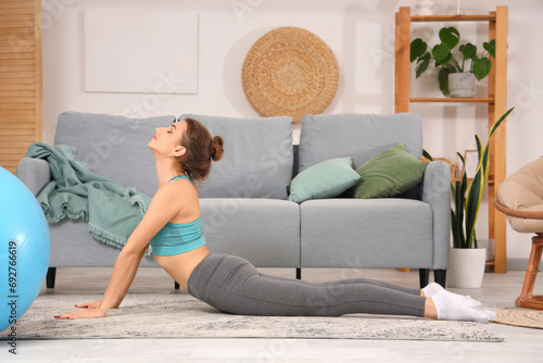 Young woman doing yoga  at home photo