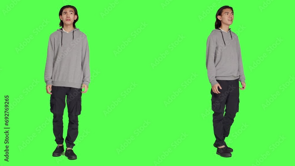 Male model having shocked reaction after seeing something, saying wow and being surprised by it. Asian person in shock admiring beautiful view, feeling pleased over greenscreen. Male model having shocked reaction after seeing something, saying wow and being surprised by it. Asian person in shock admiring beautiful view, feeling pleased over greenscreen.
