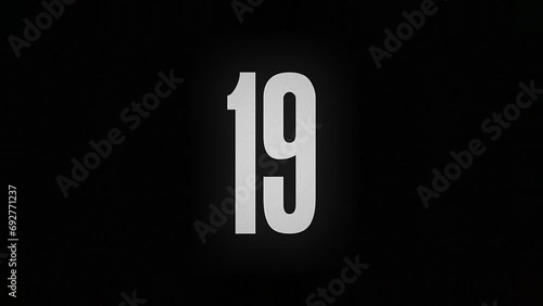 The number 19 burns down and turns into ashes on a black background photo