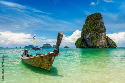 Long tail boat on tropical beach (Pranang beach) and rock, Krabi, Thailand