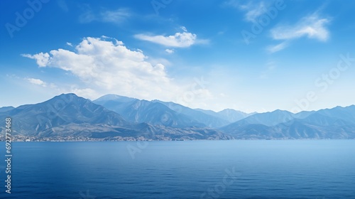 Landscape of majestic mountains and the serene expanse of the sea.