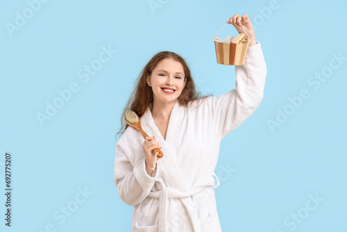 Young woman in bathrobe wit...