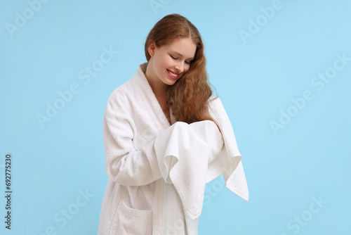 Young woman in bathrobe wip...