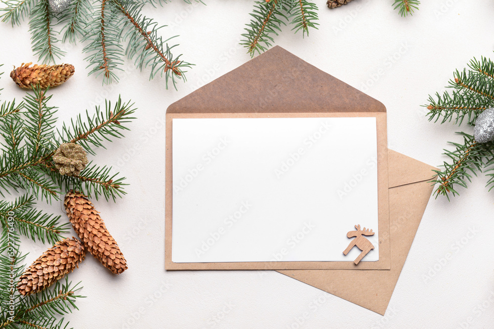 Obraz premium Blank paper with envelopes, fir branches and pine cones on white background. Letter to Santa
