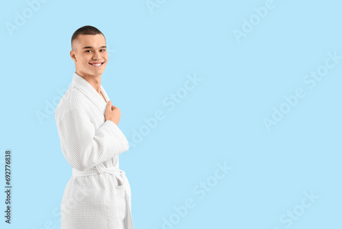Teenage boy in bathrobe on ...