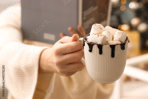 Woman holding cup of hot ch...