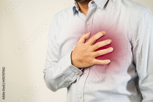 the man pressed his chest with a painful expression. Severe heartache, having a heart attack or painful cramps, heart disease