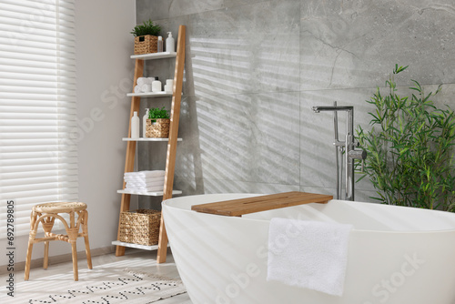 Different potted artificial plants in bathroom. Home decor