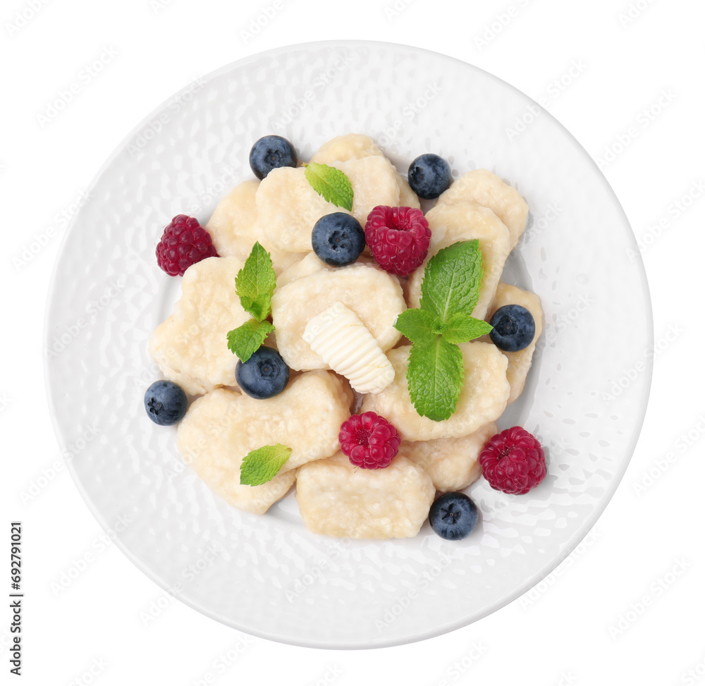 Plate of tasty lazy dumplings with berries, mint leaves and butter isolated on white, top view Plate of tasty lazy dumplings with berries, mint leaves and butter isolated on white, top view