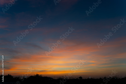 Twilight in the Evening with Orange Gold Sunset  Real amazing panoramic sunrise or sunset sky with gentle colorful clouds. Nature background  Sky background.