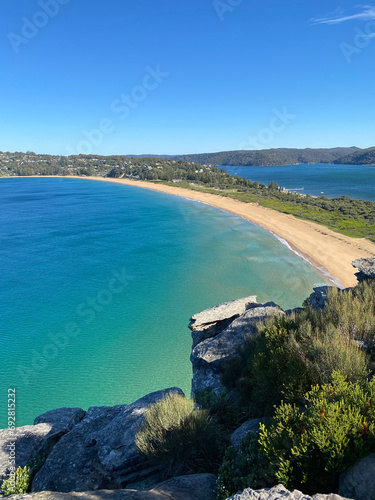 Narrow peninsular is surrounded by water on two sides. Panorama of the ocean. View of the beach and the island's coastline. Palm beach, Australia, NSW. Beach that divides the ocean.