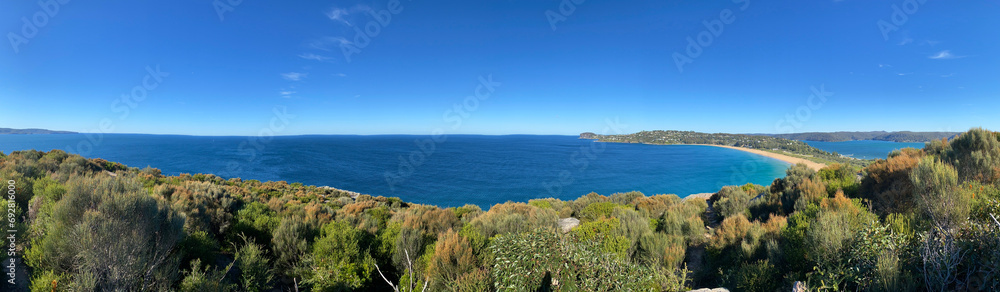 Panorama of the ocean. View of the beach and the island's coastline. Palm beach, Australia, NSW. Beach that divides the ocean.