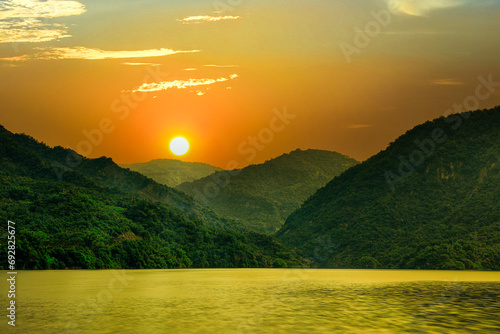 Beautiful mountain landscape silhouette at sunrise..Colorful sky cloud scene and golden lake water view form a scenic scenery. High quality photo photographed in Zengwen Reservoir,Tainan,Taiwan. photo