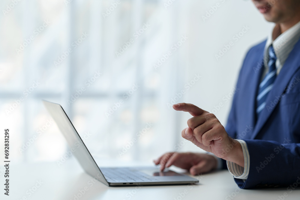 businessman working on laptop computer Print email check work Send information online on white desk Finger pointing at business goals planning success in office. businessman working on laptop computer Print email check work Send information online on white desk Finger pointing at business goals planning success in office.