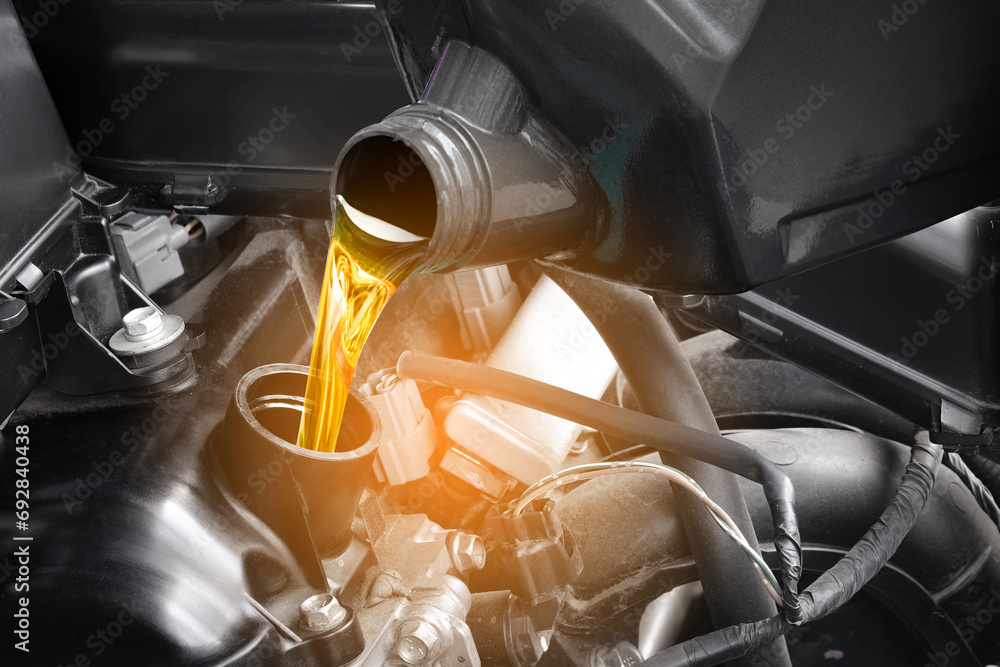 Refueling and pouring oil quality into the engine motor car Transmission and Maintenance Gear .Energy fuel concept.	
 - obrazy, fototapety, plakaty 