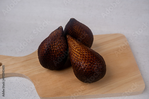 Snakefruits on wooden board isolated with thite background photo