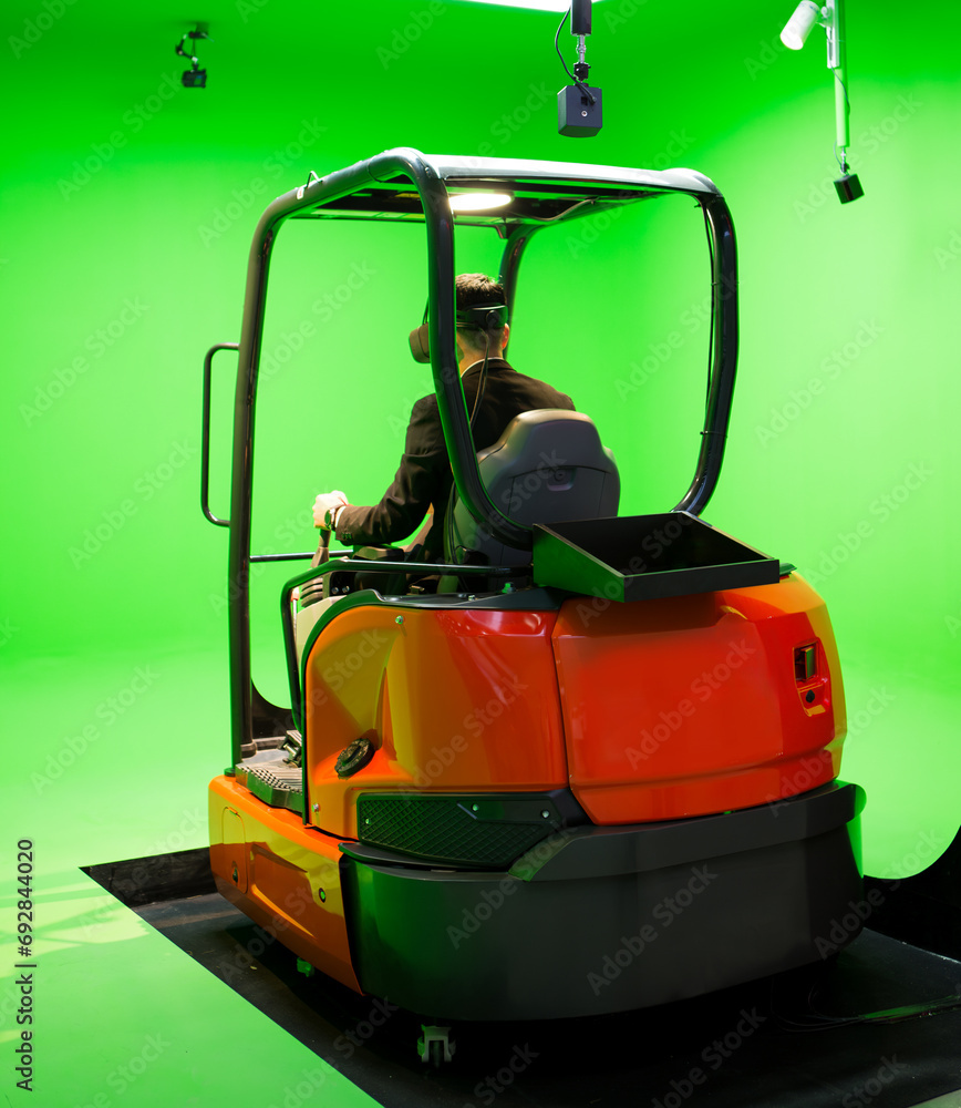 Fototapeta premium Excavator virtual simulation training. Man control excavator using VR system.