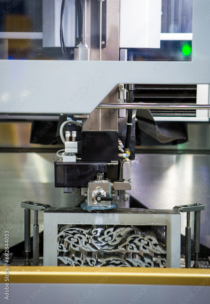 Electrical discharge machine EDM cutting metal workpiece in workshop. Industrial metalworking machinery. Electrical discharge machine EDM cutting metal workpiece in workshop. Industrial metalworking machinery.