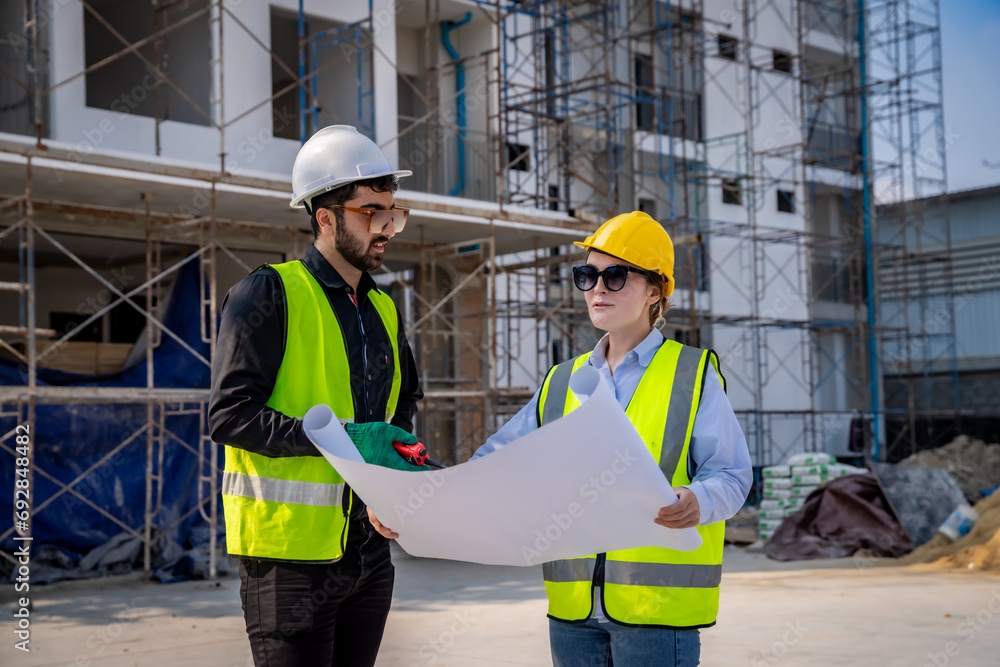 Engineer inspect building structure technicians looking at analyzing unfinished construction project Engineer inspect building structure technicians looking at analyzing unfinished construction project