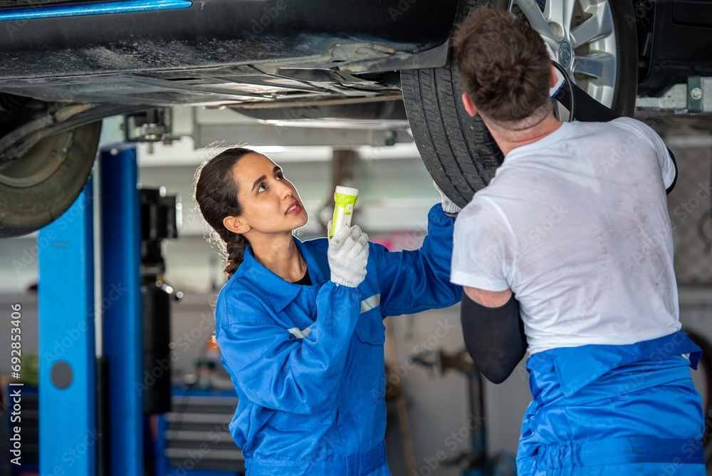 Obraz premium auto two professional mechanical technician garage motor car engine team check automobile engine for diagnostic maintain transmission machine. technician worker auto in garage check engine car motor