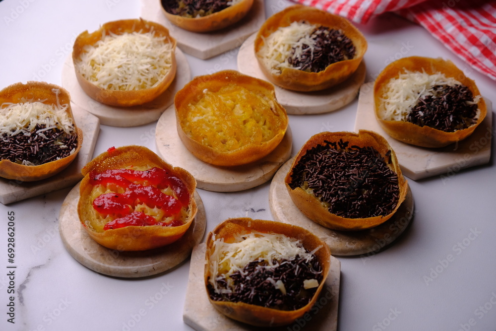 Martabak Manis. Sweet martabak. Sweet snack made from flour, eggs, vanilla, topped with grated cheese, chocolate meses, jam and pineapple, strawberry jam. Served on a white marble. Indonesian food. Martabak Manis. Sweet martabak. Sweet snack made from flour, eggs, vanilla, topped with grated cheese, chocolate meses, jam and pineapple, strawberry jam. Served on a white marble. Indonesian food.