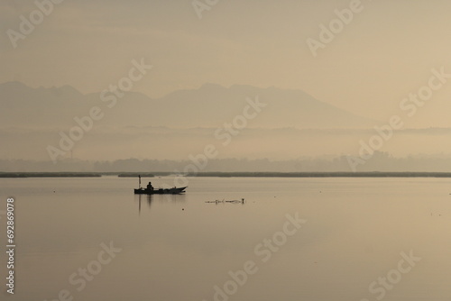 Sunrise at Batu Jai Dam, Praya, Central Lombok. A fisherman is getting ready to catch fish