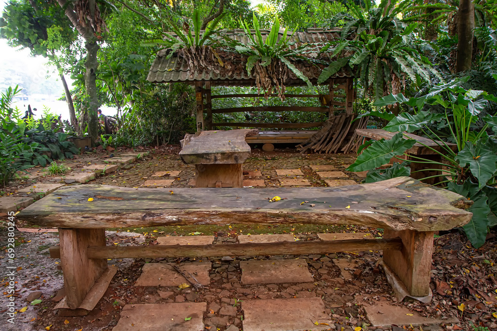 Outdoor seating area with wooden table in tropical garden