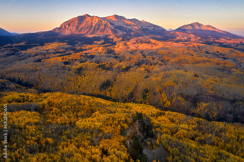 an aerial photo with two mountains in the distance and trees in the foreground, Kebler Pass, Colorad