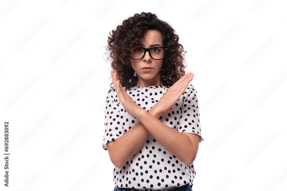 young confident leader woman with curly hairstyle dressed in summer blouse crossed her arms in front of her in disagreement young confident leader woman with curly hairstyle dressed in summer blouse crossed her arms in front of her in disagreement
