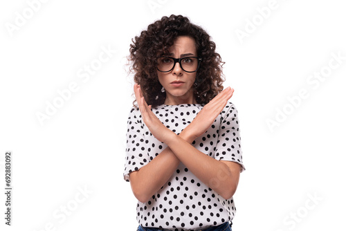 young confident leader woman with curly hairstyle dressed in summer blouse crossed her arms in front of her in disagreement