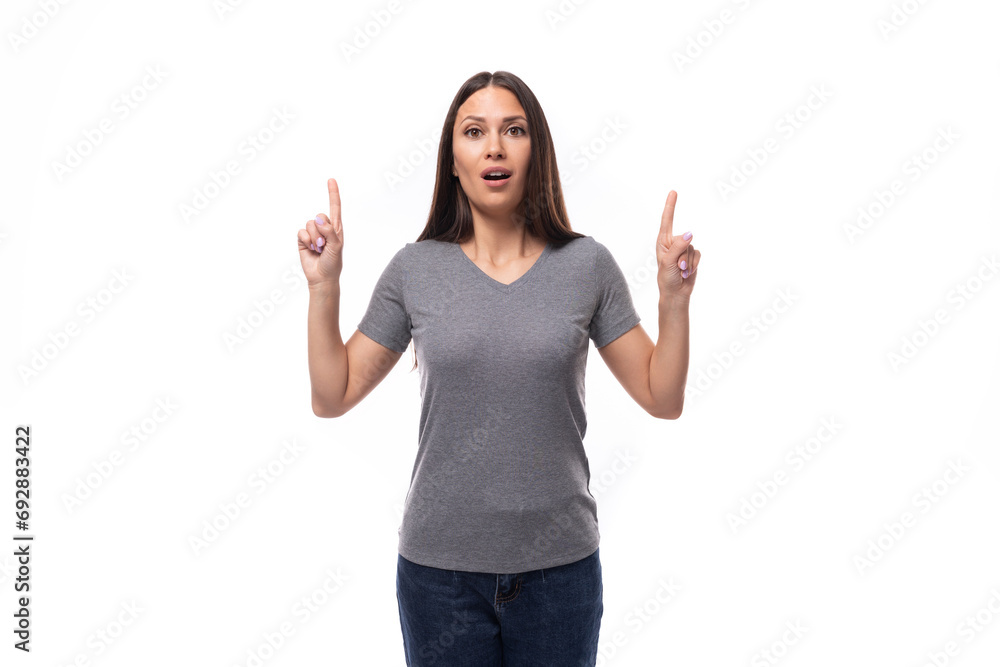 portrait of a charming young european brunette woman in gray clothes on a white background with copy space portrait of a charming young european brunette woman in gray clothes on a white background with copy space