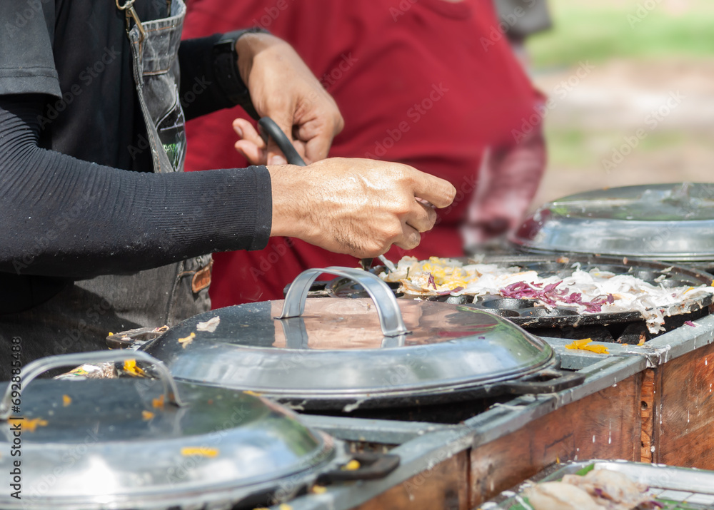 Fototapeta premium Thai Pancake, Male hands making khanom krok Traditional Thai desserts with delicious