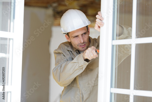 window installation process made by two construction workers