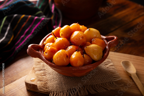 Dulce de Tejocote. Typical Mexican dessert made with Tejocote (Crataegus mexicana), a Mexican fruit in syrup, a fruit widely used in autumn, the Day of the Dead, posadas and the Christmas season. photo
