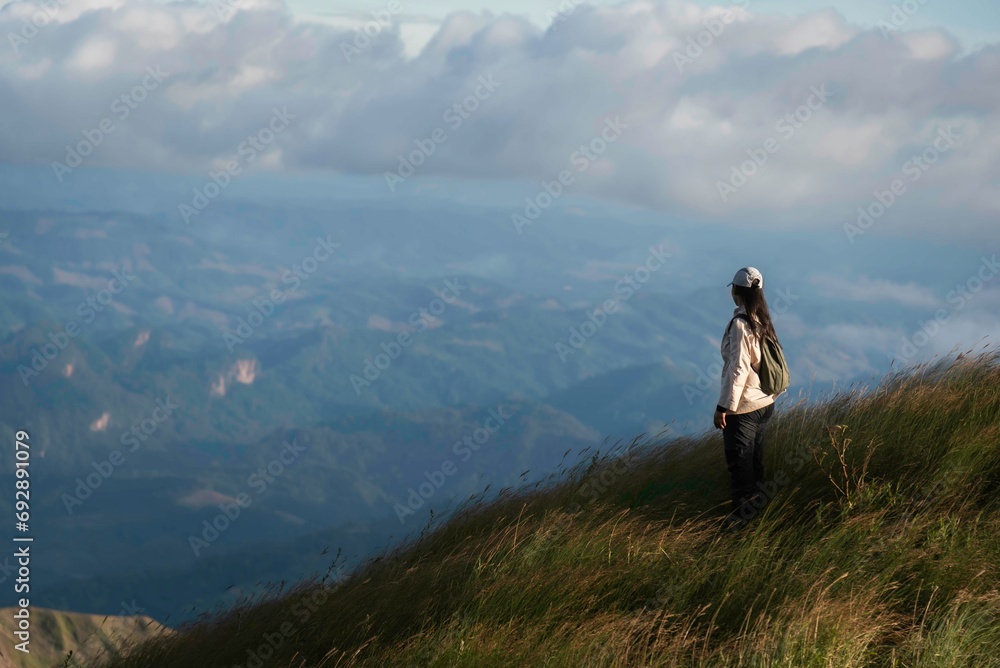 Hiker asian woman happy feeling freedom good and strong weight victorious facing on the natural mountain. Travel Concept