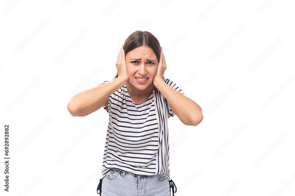 30 year old pretty brunette model woman with long straight hair covered her ears with her hands from the noise 30 year old pretty brunette model woman with long straight hair covered her ears with her hands from the noise