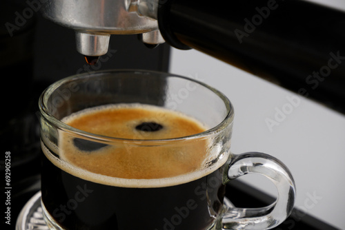 Coffee maker and espresso coffee cup on gray background.