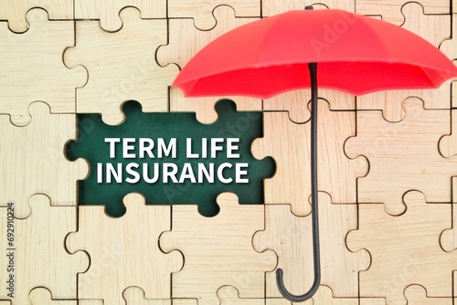 red umbrella and wooden puzzle with the word term life insurance. insurance coverage concept photo