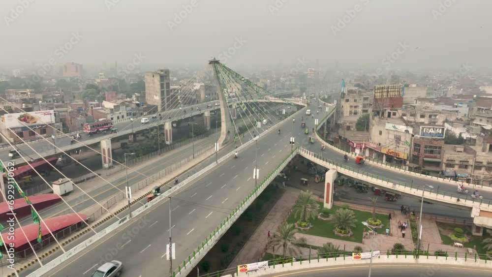Aerial drone shot over traffic movement along Azadi bridge in Pakistan during morning time. Aerial drone shot over traffic movement along Azadi bridge in Pakistan during morning time.