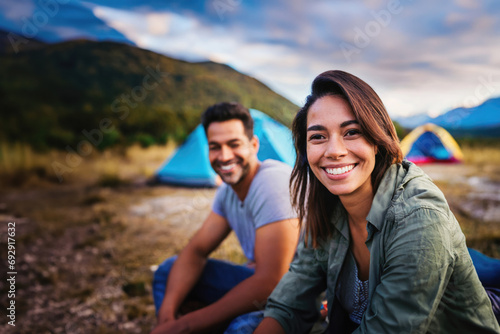 adult man and woman camping at campsite in nature, tent in background, joy and fun © Marko