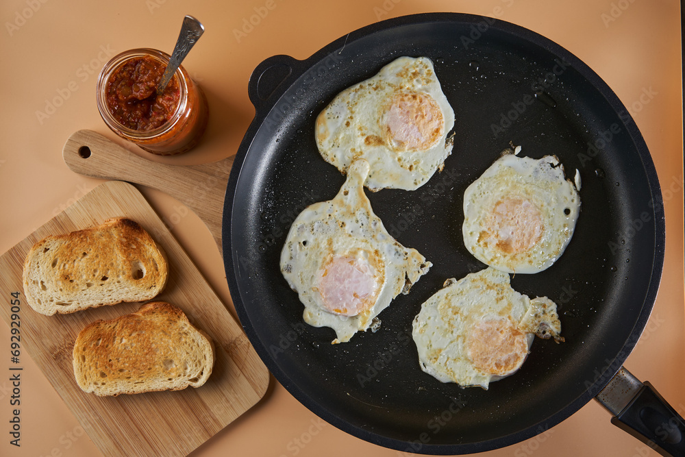 Fried eggs and vegetables chutney on toast