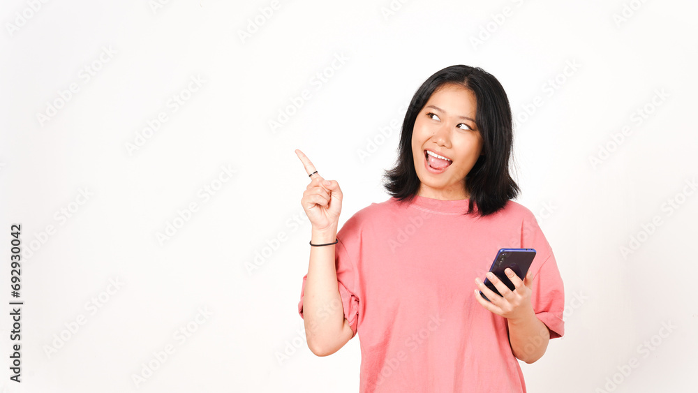 Young asian woman using mobile phone and pointing up with copy space Young asian woman using mobile phone and pointing up with copy space