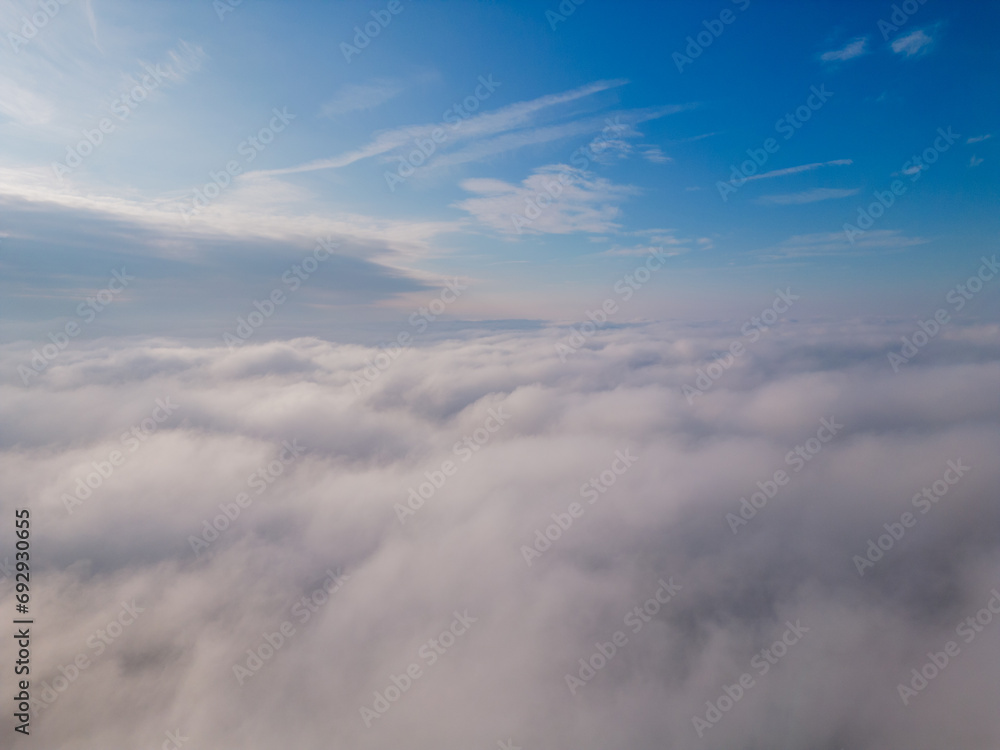 Obraz premium A drone flies over fluffy clouds. The drone flies through the clouds, creating a sense of wonder and awe