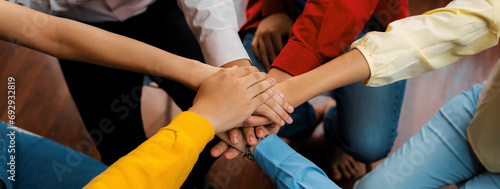 Startup company employee team stacking hand together symbolize successful group of business partnership and strong collective unity teamwork in community workplace in panoramic banner. Synergic photo