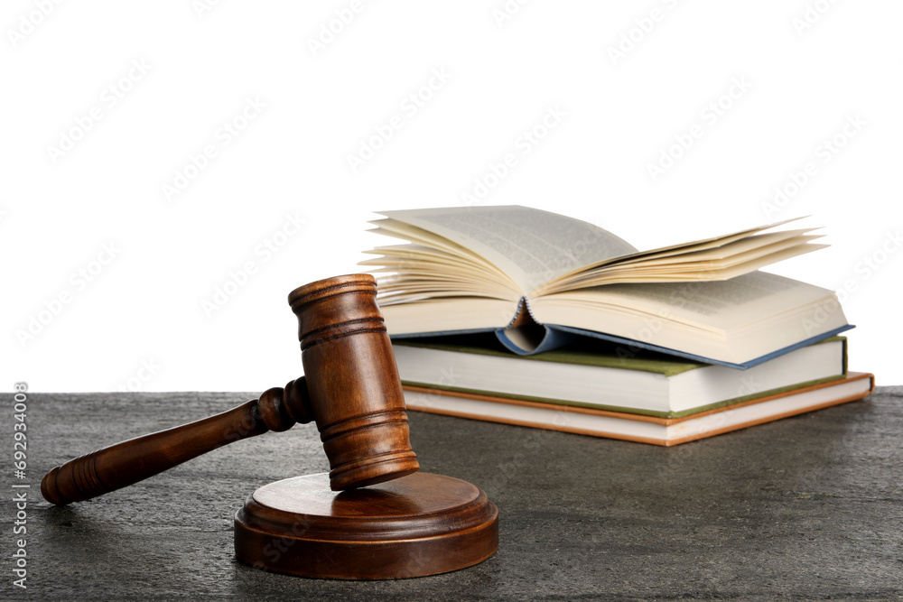Law concept. Judge's mallet and books on dark grey table against white background Law concept. Judge's mallet and books on dark grey table against white background